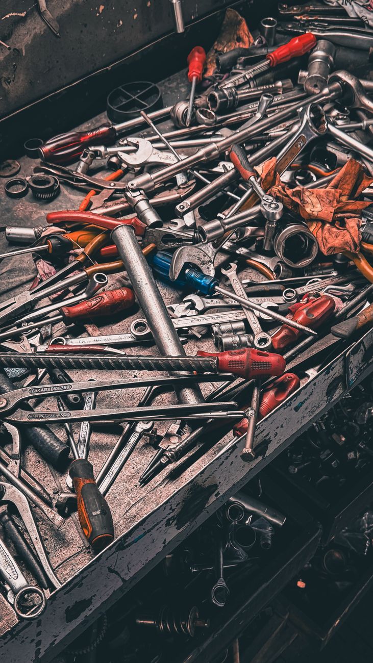 assorted hand tools on workbench in garage